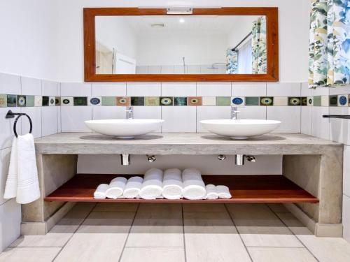 a bathroom with two sinks and a mirror at Pioneers in Victoria Falls