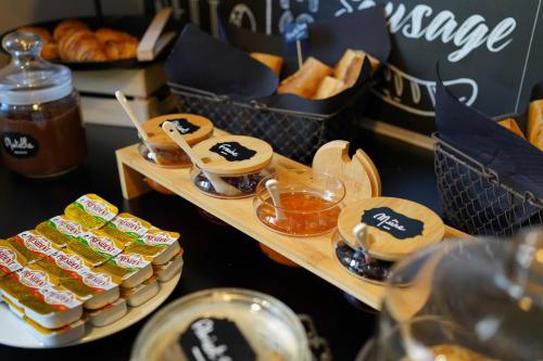 a buffet with bread and pastries and other food items at Hotel De Quebec in Rouen