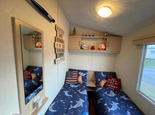 a small room with two beds in a trailer at Steeple Bay F79 in Steeple