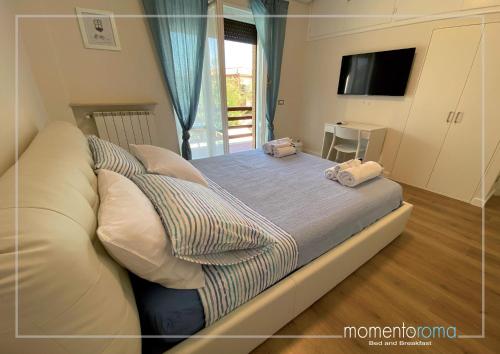Postel nebo postele na pokoji v ubytování Momentoroma b&b