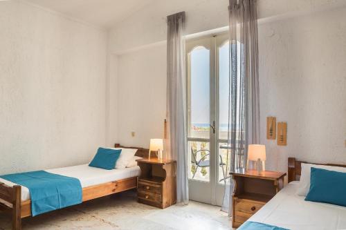 a bedroom with two beds and a window at Sunset Beach Appartments in Minia
