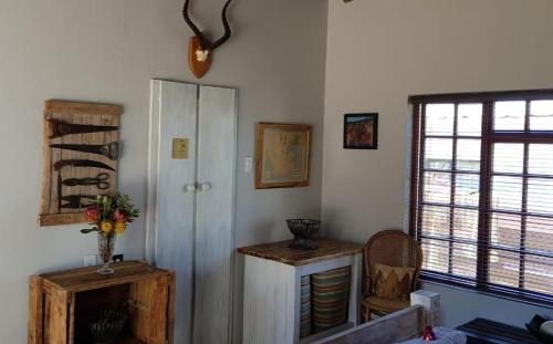 a living room with a cabinet and a window at StarFish Accommodation in Struisbaai