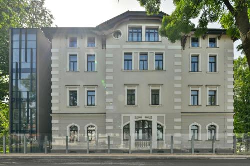 a large white building with windows at Heritage Hotel Krone in Sarajevo