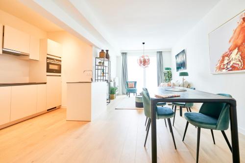 a kitchen and dining room with a table and chairs at Diamant 1BR in Brussels
