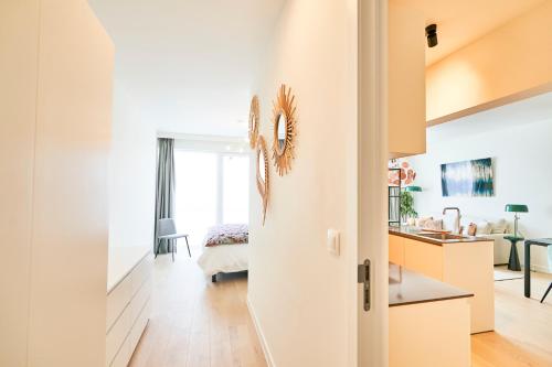 a living room with a door leading to a bedroom at Diamant 1BR in Brussels
