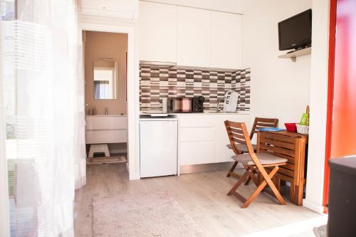 a small kitchen with a table and a desk at Casinhas do Minho in Arcos de Valdevez