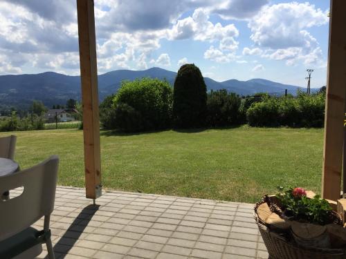 a patio with a view of a field of grass at Penzion Na Vyhlídce in Frýdlant nad Ostravicí