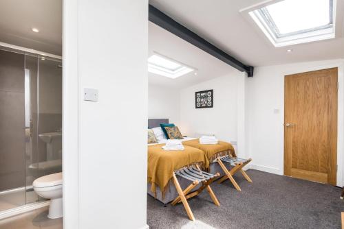 a bedroom with a bed and a bathroom with a toilet at Liverpool Waterfront Stay, excellent location , parking available in Liverpool