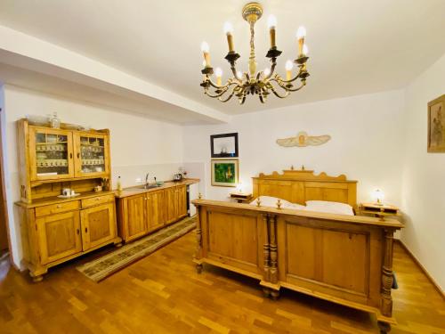 a large room with wooden furniture and a chandelier at Agroturystyka „Na Połomiu” in Istebna