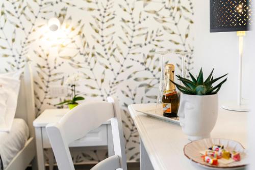 a table with a bottle of beer and a plate of food at Via Barocca in Ragusa
