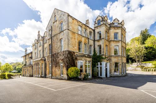 an old stone house with a parking lot in front of it at Best Western Limpley Stoke Hotel in Bath