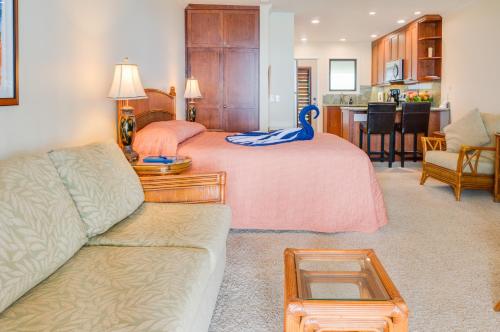 a bedroom with a bed with a blue swan on it at Hale Napili in Lahaina