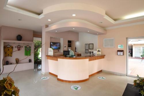 a large lobby with a reception counter in a building at Villa Esmeralda in San Juan Bautista Tuxtepec
