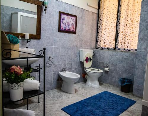 a bathroom with a toilet and a sink at Cavour Il Conte Camillo in Palermo