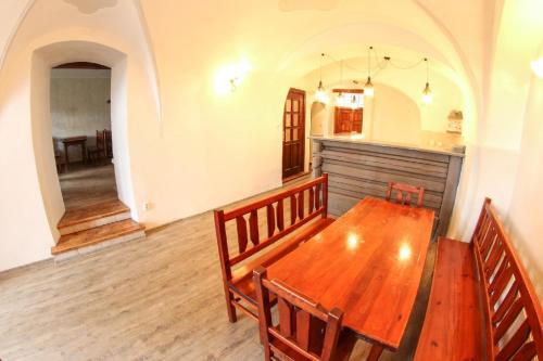 a dining room with a wooden table and chairs at Apartmány Na Rynku Chvalšiny 18 in Český Krumlov