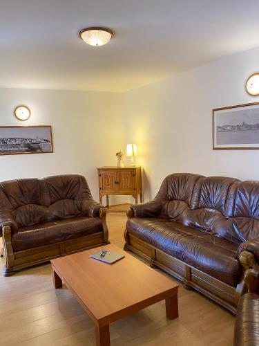 a living room with two leather couches and a coffee table at Villa Adria in Vodice