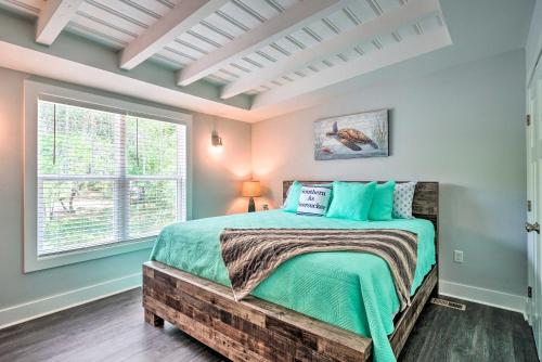 a bedroom with a bed and a window at Modern Oak Island Escape 1 Mile to Long Beach! in Oak Island