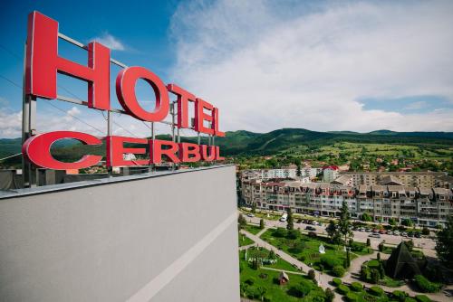 a sign for a hotel in a city at Complex Balnear Cerbul in Covasna