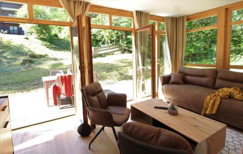 a living room with a couch and a table at Bad Kleinkirchheim RMG family apartments in Bad Kleinkirchheim