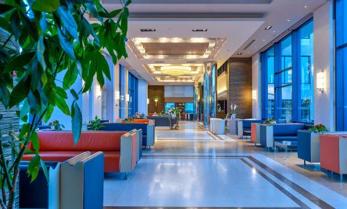 a lobby of a building with blue and red furniture at Porto Platanias - Casa Di Porto in Plataniás