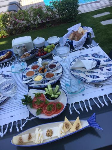 a table with plates of food on top of it at Villa Oliva Butik Hotel in Bodrum City