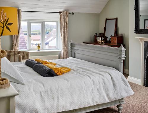 a bedroom with a bed with towels on it at The Martlet Inn in Wellington