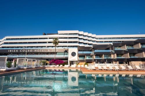 a hotel with a swimming pool in front of a building at Ibiza Corso Hotel & Spa in Ibiza Town