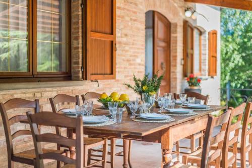 a wooden table with plates and bowls of fruit at Villa Durante in Cagli