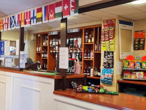 a store counter with a lot of bottles of alcohol at The Beechfield Hotel in Blackpool