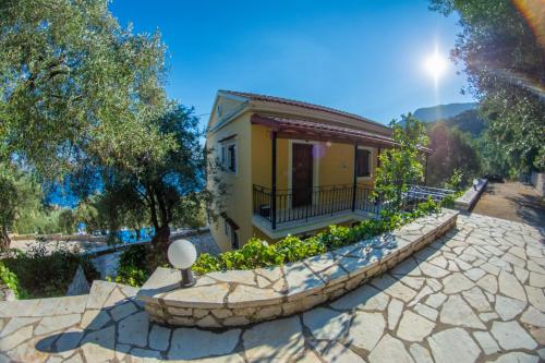 a house with a stone walkway in front of a building at Amalia Complex in Nisakion