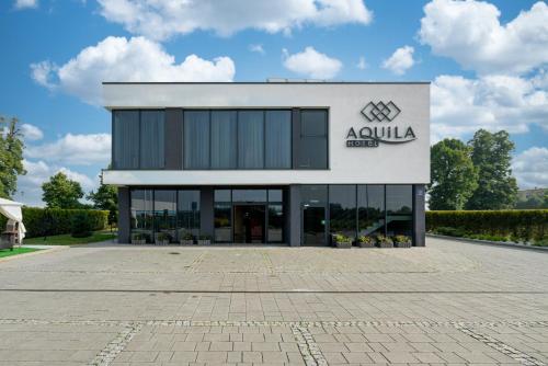 a building with theania logo on the side of it at Aquila Hotel in Zator