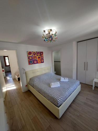 a bedroom with a bed and a chandelier at Ca' Venice Canal View in Venice