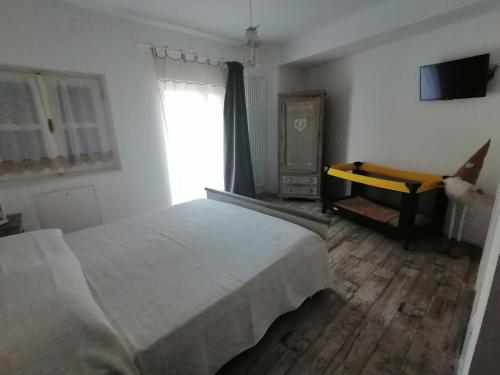 a bedroom with a bed and a television and a window at DOLCE DORMIRE in Rovereto