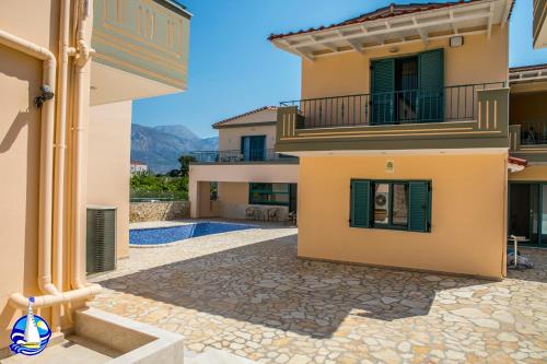 a villa with a view of the swimming pool at Anemos Villas in Mitika