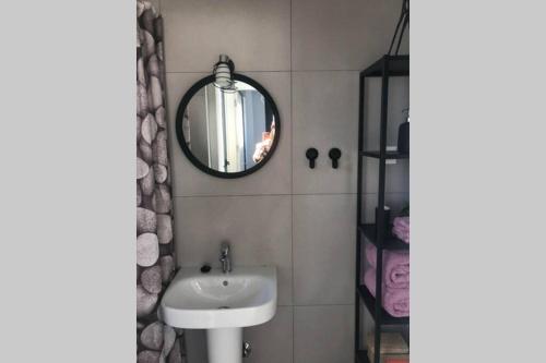 a bathroom with a sink and a mirror at Villa Isla Plana - right by the sea in Isla Plana