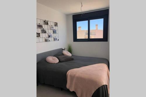 a bedroom with a bed with two pillows on it at Villa Isla Plana - right by the sea in Isla Plana