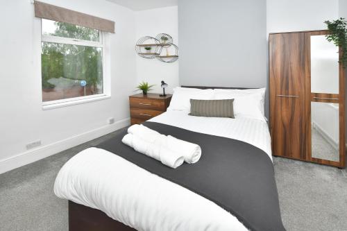 a bedroom with two beds and a window at Boothen House by YourStays in Stoke on Trent