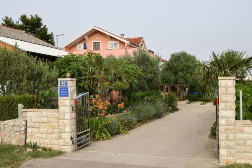a driveway with a gate and a house at Apartment Olive in Jovići