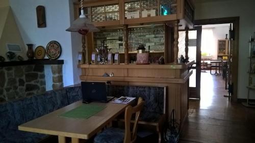 a bar with a wooden table with a laptop on it at Pension Zschirnsteinbaude in Kleingießhübel