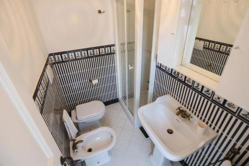 a bathroom with a white toilet and a sink at Casa di charme panoramica a Capri sulla spiaggia. in Capri