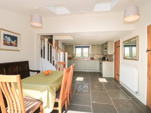 a kitchen and dining room with a table and chairs at Lilac Cottage in Wells