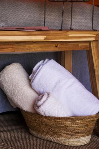 a basket filled with towels under a table at Little Canvas Escape in Nes