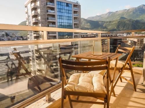 a balcony with a table and chairs on a balcony at Four Views Apartments in Budva