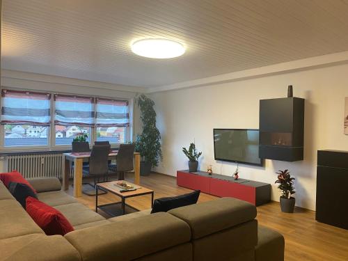 a living room with a couch and a flat screen tv at Ferienwohnung Nuß in Annweiler am Trifels