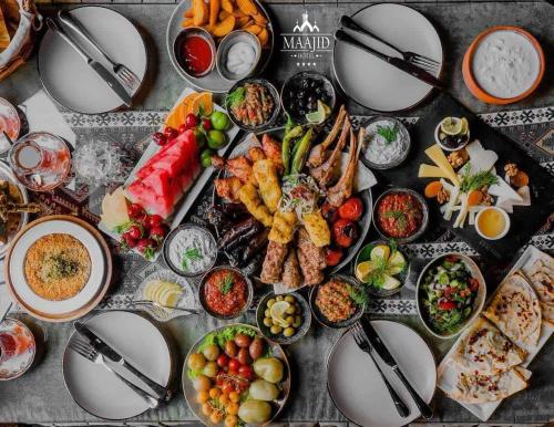 a table topped with plates of food on a table at Maajid Boutique Hotel in Baku