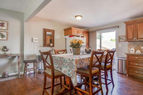 a kitchen with a table and chairs and a kitchen with a window at Fly Away Home in West Jordan