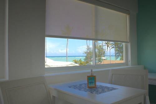 a table with a window with a table and a candle on it at Hotel Checkin El Cortecito Beach in Punta Cana