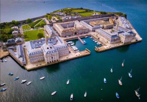 an aerial view of a city with boats in the water at Luxurious "THE BRUCE" - - LARGE FAMILY APARTMENT and DELUXE STUDIO That CONNECT IN PRIVATE LOBBY - - Beautifully Refurbished - - FREE Onsite PARKING in Plymouth