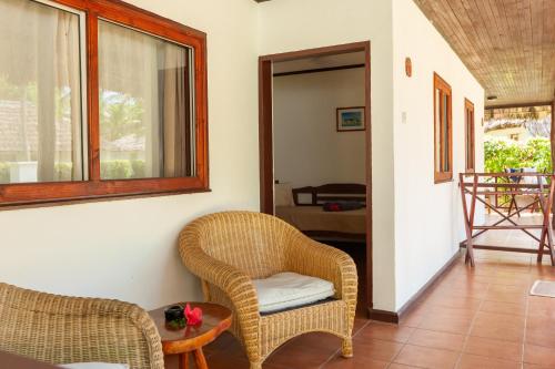 a living room with two chairs and a table at Hotel Cote d'or Lodge in Baie Sainte Anne