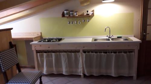 a kitchen with a sink and a stove at Appartamento centro storico in Riva del Garda
